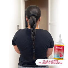 African-American woman with long natural braided ponytail.