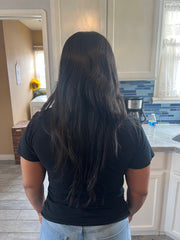 African-American woman with long natural straightened hair.